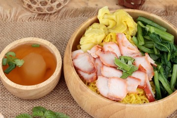 Egg noodles with pork and dumpling in soup.