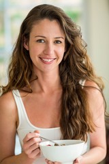 Portrait of beautiful brunette woman having breakfast