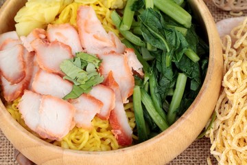 Egg noodles with pork and dumpling in soup.