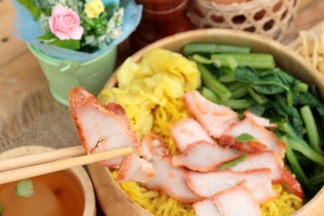 Egg noodles with pork and dumpling in soup.