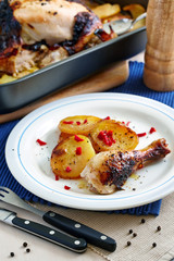 baked chicken drumstick and potatoes