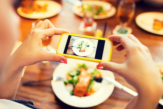 hands photographing food by smartphone 