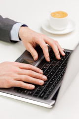 Fototapeta na wymiar close up of businessman hands typing on laptop