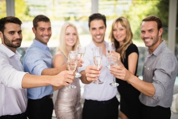 Group of friends holding glasses of champagne