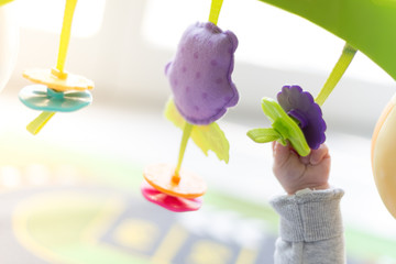 Happy newborn baby playing