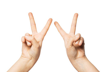 close up of hands showing peace or victory sign