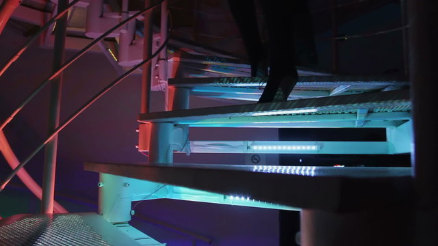 Couple going up the stairway, entering nightclub. Cool party, relaxation