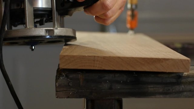 A Carpenter Using A Router To Shape Wood