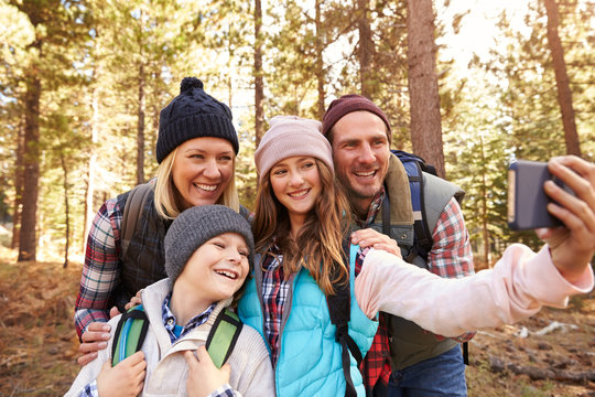 Family On Hike In A Forest Taking Selfie Group Portrait