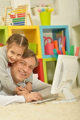 father and little daughter  with computer
