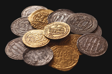 Ancient islamic golden and silver coins isolated on black