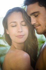 Young couple embracing in garden