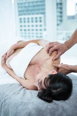 Pregnant woman receiving a back massage from masseur