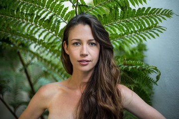 Portrait of beautiful woman standing outdoors in garden