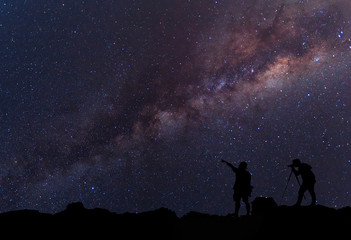 Obraz na płótnie Canvas Star-catcher. A person is standing next to the Milky Way galaxy