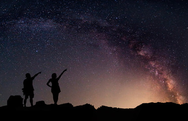 Obraz na płótnie Canvas Star-catcher. A person is standing next to the Milky Way galaxy