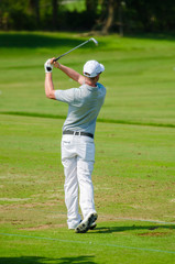 Golfer hitting golf shot.