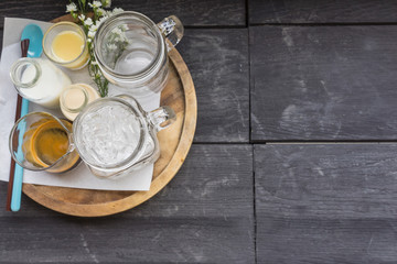 Coffee-set with raw sugar and milk on the wood