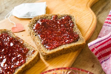  raspberry jam and a slice of black bread