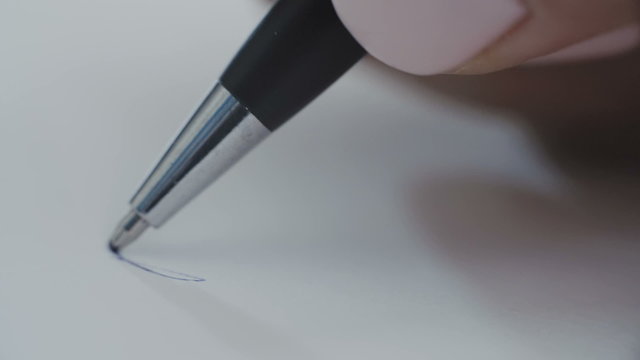 Woman with a blue ball pen writing letters
