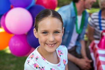 Fototapeta na wymiar Smiling little girl at birthday party