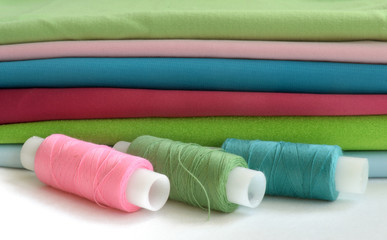 Fototapeta na wymiar a stack of colorful fabric and thread