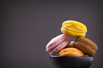 French colorful macarons on grey background