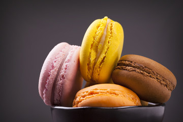 French colorful macarons on grey background