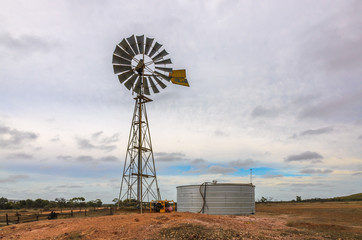 Australian outback old  retro wind powered water pump and storag