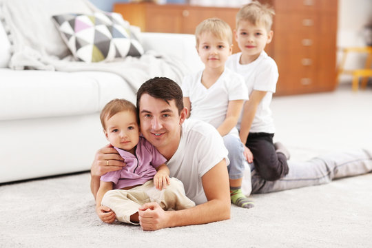 Family concept. Father with sons are playing in the room