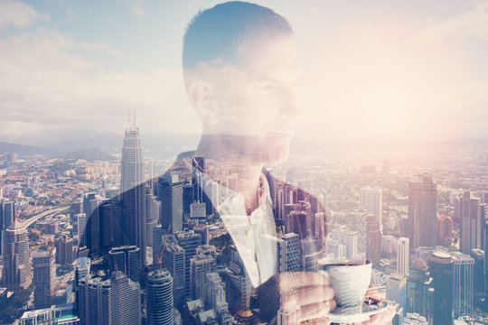 Photo of stylish adult businessman wearing trendy suit and holding cup coffee. Double exposure, panoramic view contemporary city sunset. Horizontal