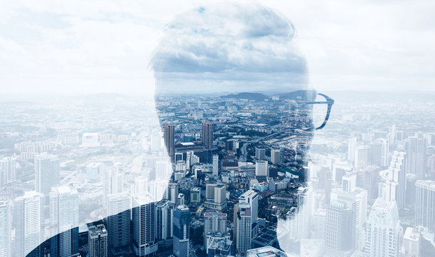 Photo of stylish bearded banker wearing trendy suit and looking city. Double exposure, panoramic view contemporary megalopolis background. Space for your business message. Wide