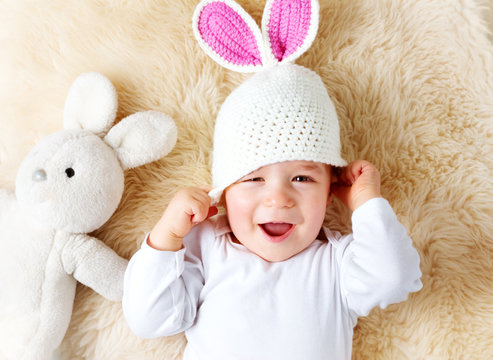 One Year Old Baby Lying In Bunny Hat On Lamb Wool