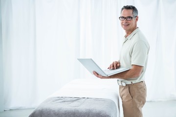 Physiotherapist using laptop