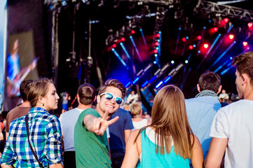 Teenagers at summer music festival having fun