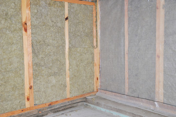 Interior House Wall Insulation with Wind Protection Film. Fiberglass Insulation. Insulation Materials.