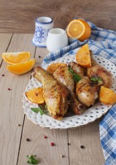 Roasted chicken legs in cast iron skillet, selective focus