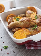 Roasted chicken legs in cast iron skillet, selective focus