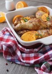Roasted chicken legs in cast iron skillet, selective focus