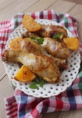 Roasted chicken legs in cast iron skillet, selective focus