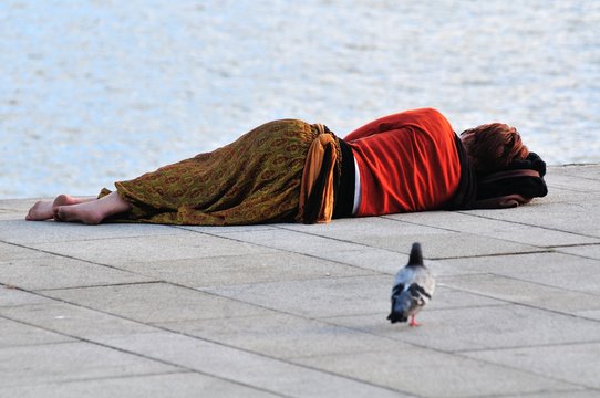 Unrecognizable Woman Sleeping Besides the Sea