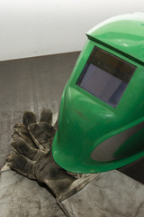 Green welding helmet with work gloves