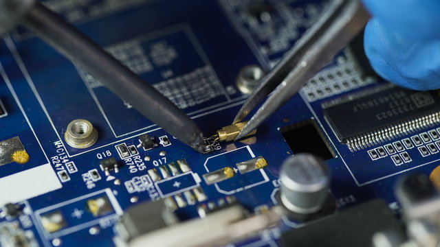Repair of computer board. soldering microchips and circuit boards