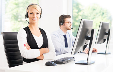 Customer support operators in formalwear working using computers