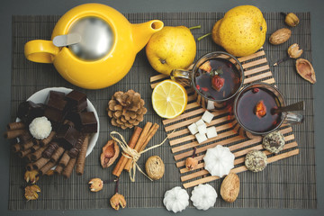 Two glass cups of tea with lemon and sweets