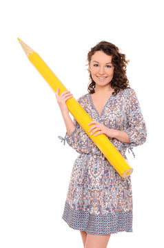 young pretty woman with giant yellow pencil
