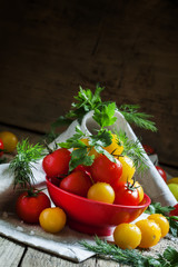 Mix red and yellow cherry tomatoes, parsley and dill in red bowl