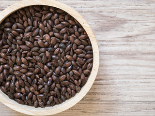 Top view - Beer ingredients, Chocolate malt on wooden background ( Space and composition for text )
