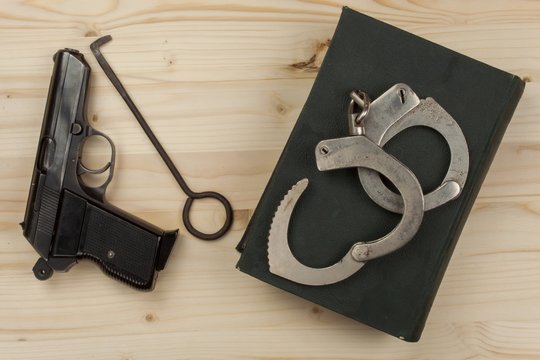 Crime and Punishment. Equipment criminals. The Book of of laws with handcuffs. Law and order.
