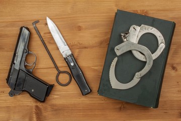 Crime and Punishment. Equipment criminals. The Book of of laws with handcuffs. Law and order.
